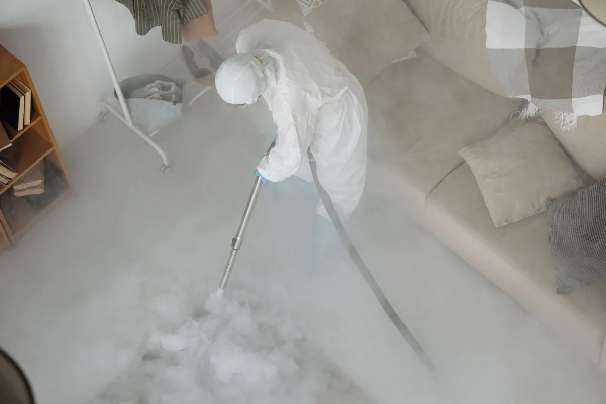 Biohazard cleanup technician in protective equipment, Valdez, AK